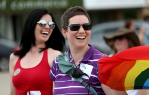 Michelle McHale and Karen Phillips, organizers leading thousands of people who attend the first Pride march in Steinbach, Manitoba, Saturday, July 9, 2016. (THE CANADIAN PRESS / Trevor Hagan)