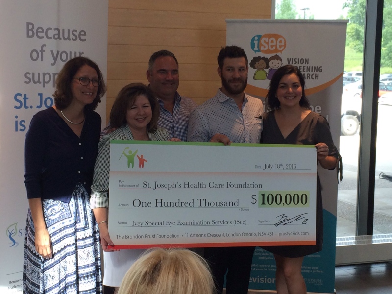 Brandon Prust, second from right in back, makes a $100,000 donation through his foundation to support vision screening for young children in London, Ont. on Monday, July 18, 2016.
