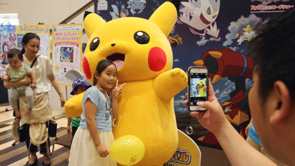 A girl poses with Pikachu
