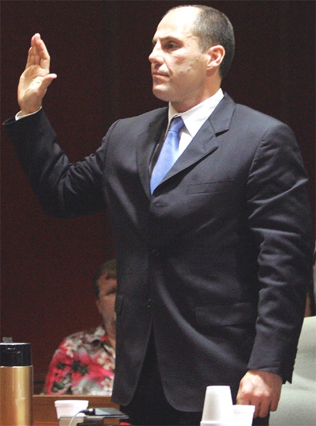 Former hockey star Rick Tocchet, 43, left, holds up his right hand as he stands in Burlington County Superior Court on May 25, 2007, in Mount Holly, N.J. (AP / Mel Evans)