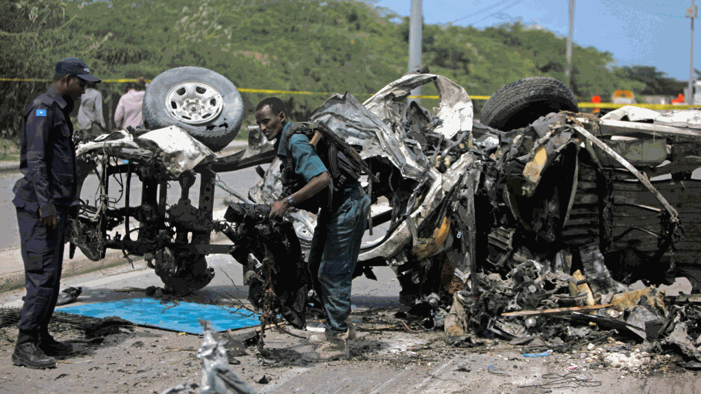 Somali soldiers check the wreckage of a car bomb 