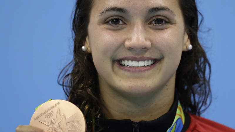 Canada's Kylie Masse shows off her bronze medal during the ceremony for the women's 100-metre backstroke final during the swimming competitions in Rio de Janeiro, Brazil at the Rio 2016 games on Monday, Aug. 8, 2016. (AP / Michael Sohn)