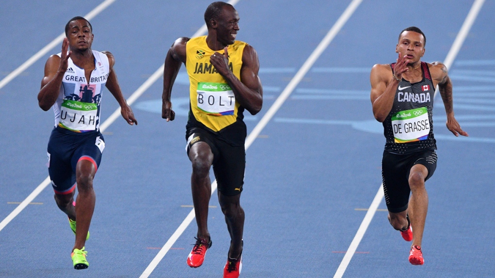 Usain Bolt smiles at Andre De Grasse