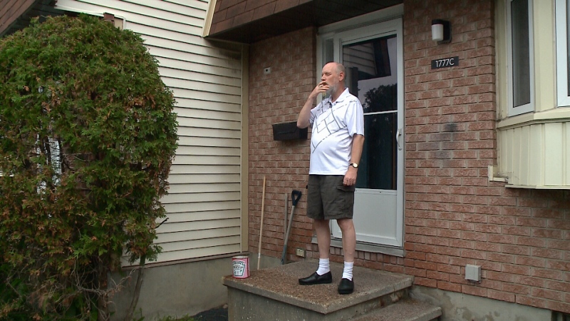 Chris Reed, who intervened during a vicious dog attack over the weekend, stands outside his house in Orléans.