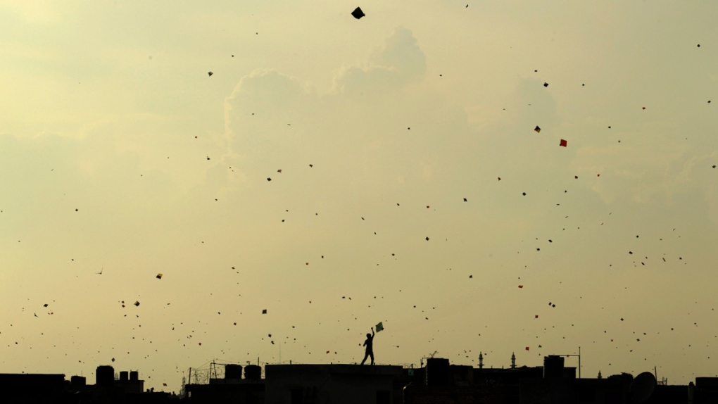 A boy flies a kite in New Delhi, India