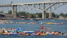 In this Sunday, Aug. 16, 2015, photo, floaters head down the St. Clair River during the annual float down, in Port Huron, Mich. The float down starts a Lighthouse Beach in Lake Huron and ends in south Port Huron and Marysville. (Andrew Jowett/The Times Herald via AP) 