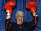 In this file photo, then-Conservative candidate for Saint John, Elsie Wayne, raises her hands after receiving a pair of boxing gloves from a man dressed in a blue Santa suit during her nomination meeting in Saint John, N.B. Monday Oct. 23, 2000. (THE CANADIAN PRESS/Jacques Boissinot)