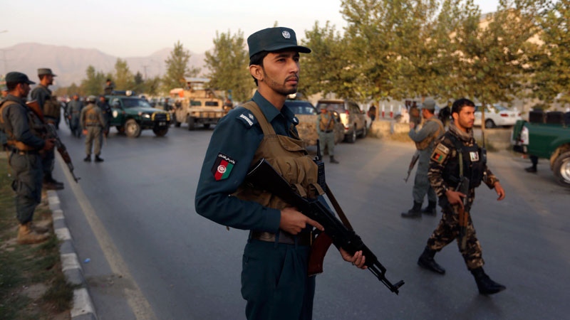 Afghan security forces stand guard after attack