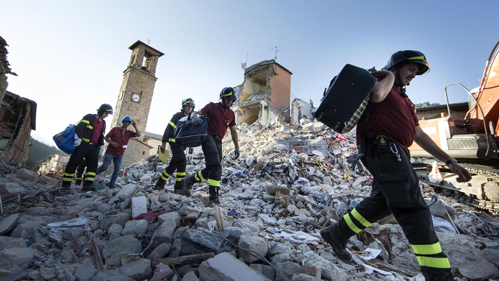 Firefighters carry personal belongings in Italy