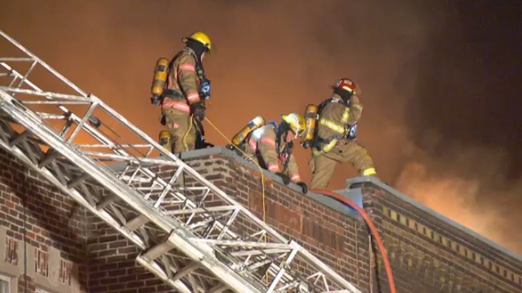 Firefighters on the roof of an apartment 