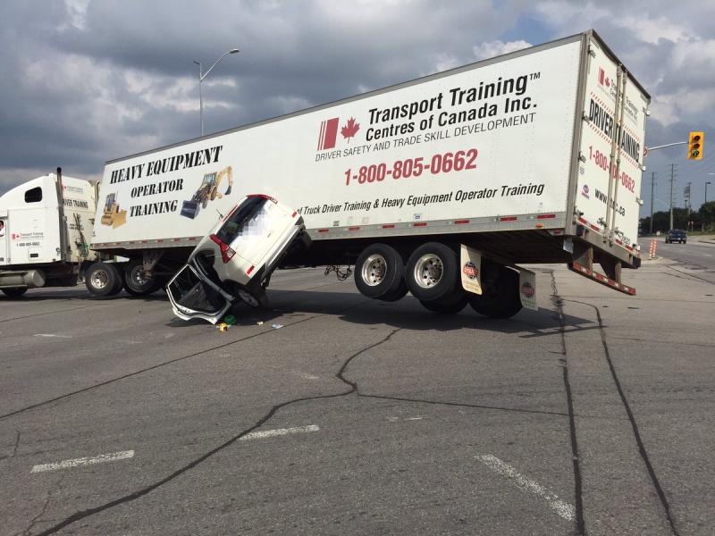 A SUV was partially lifted off the ground in a crash with a transport truck in Barrie, Ont. on Wednesday, Sept. 7, 2016. (Barrie Police Service/ Twitter)
