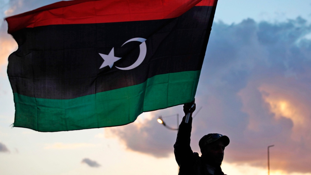 A Libyan waves the national flag in Benghazi