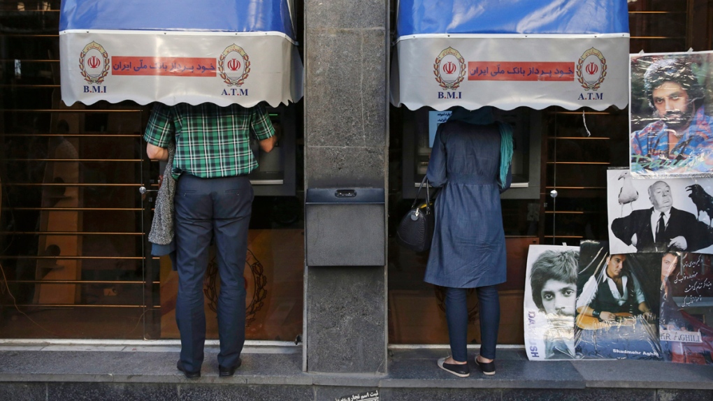 Iranians use ATM machines in Tehran