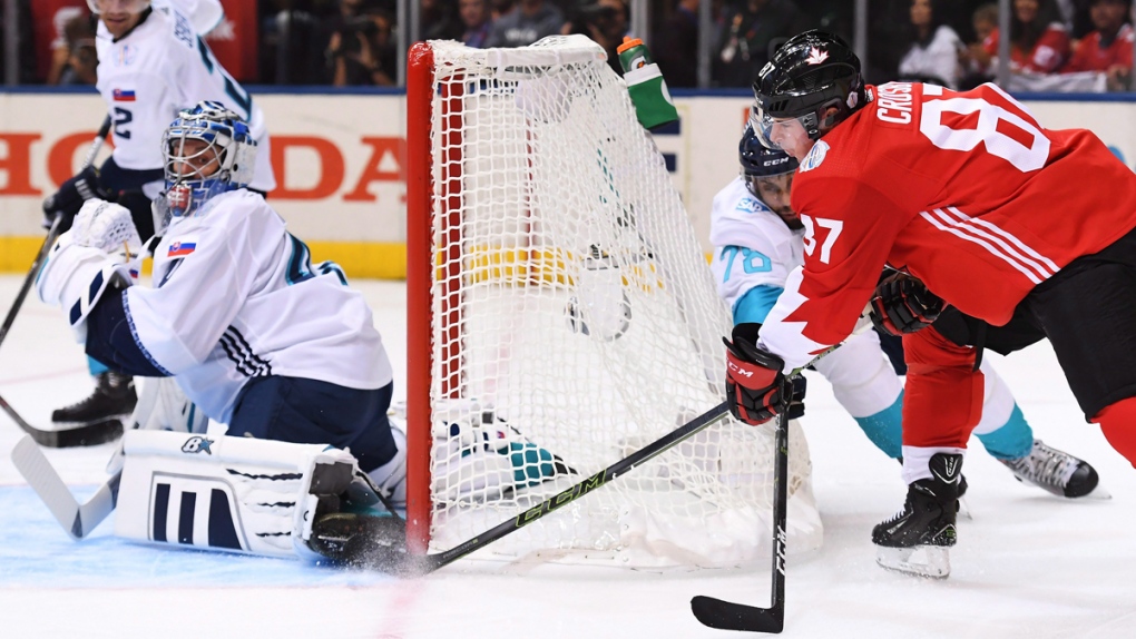 Team Canada's Sidney Crosby, right, scores
