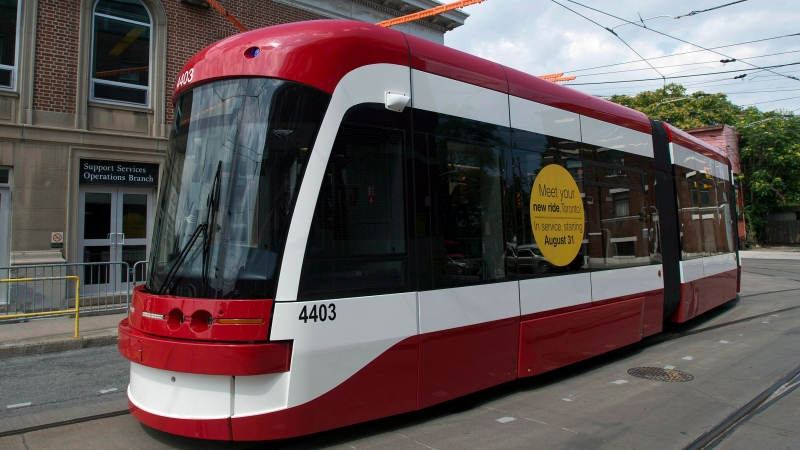 A new Toronto Transit Commission streetcar rounds a turn in Toronto on Thursday, July 31, 2014. (The Canadian Press/Frank Gunn)