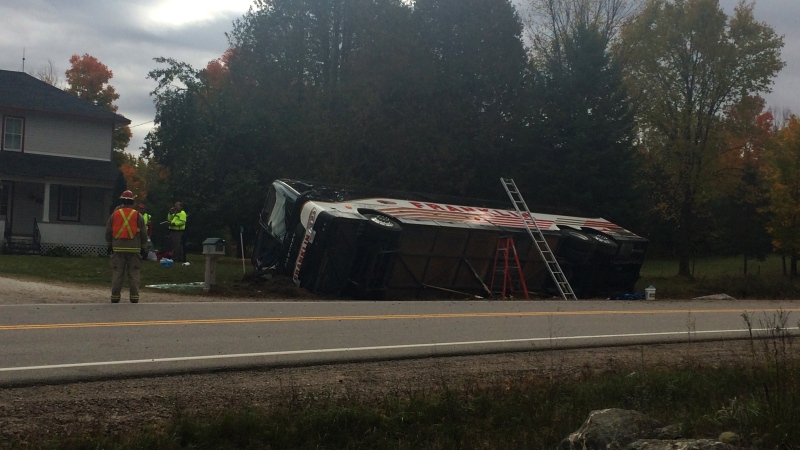 A bus is seen laying on its side in a ditch in Denbigh, Ont. on Friday, Oct. 14, 2016. 14 people were injured. 