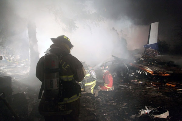 Firefighters work to extinguish the fire at the site of the crash of Continental Connection Flight 3407 in Clarence Center, N.Y., Friday, Feb. 13, 2009. (AP / Charles Anderson)