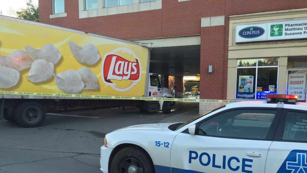 Truck hits building