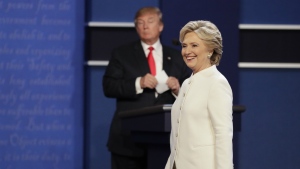 Democratic presidential nominee Hillary Clinton walks toward the audience as Republican presidential nominee Donald Trump stands behind his podium after the third presidential debate at UNLV in Las Vegas on Wednesday, Oct. 19, 2016. (AP / John Locher)