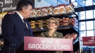 Ontario Premier Kathleen Wynne, right, and Finance Minister Charles Sousa, left, appear at a press conference in a Toronto supermarket on Thursday, Feb. 18, 2016 to formally announce that her government will open up wine sales in grocery stores across Ontario. THE CANADIAN PRESS/Michelle Siu