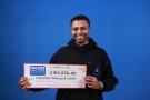 Nishanthan Selvaraj holds his cheque for $100,026 after winning the Oct. 5, 2016 Encore draw. (OLG)