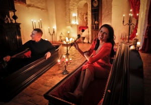 Events manager Tami Varma and her brother Robin, a PhD student, the grandchildren of Devendra Varma, a scholar of English gothic tales and an expert in vampire lore, pose in coffins at Bran Castle, in Bran, Romania, Monday, Oct. 31, 2016. A Canadian brother and sister are passing Halloween night curled up in red velvet coffins in the Transylvanian castle that inspired the Dracula legend, the first time in 70 years anyone has spent the night in the gothic fortress after they bested 88,000 people who entered a competition hosted by Airbnb to get the chance to dine and sleep at the castle in Romania. (AP Photo/Vadim Ghirda)