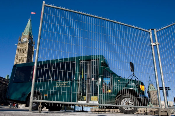A Parliamentary shuttle bus passes through a temporary security fence on Parliament Hill in Ottawa, Monday, Feb. 16, 2009. (Adrian Wyld / THE CANADIAN PRESS)