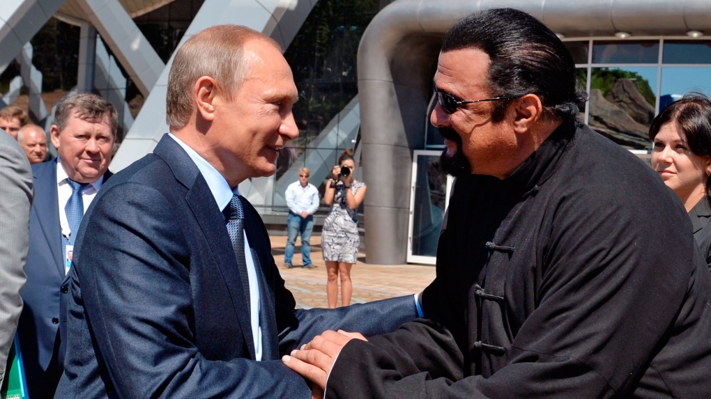 Putin and actor Steven Seagal shake hands
