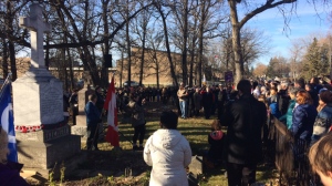 The cenotaph in St. Norbert marking the names of 13 soldiers killed in the First World War was hidden beneath overgrown flowers until Art Bloomfield noticed it in 2008. In 2016, a crowd of 500 people gathered to mark Remembrance Day. (Photo: Josh Crabb/CTV Winnipeg)