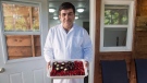 Assam Hadhad, a Syrian refugee who arrived in Canada last year, displays a tray of chocolates at his shop, Peace by Chocolate, in Antigonish, N.S. on Wednesday, Sept. 21, 2016. (Andrew Vaughan/The Canadian Press)