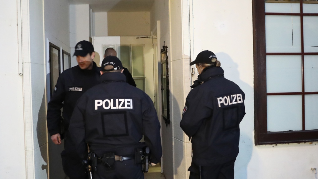 Police officers enter a mosque in Hamburg, Germany