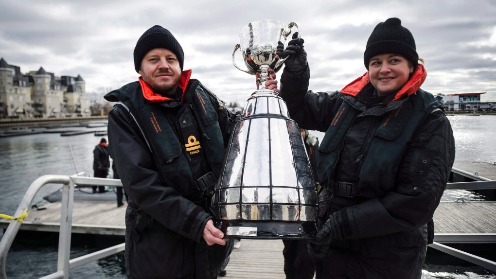 Royal Canadian Naval officers carry the Grey Cup 