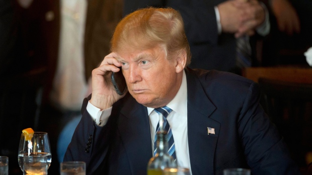 Donald Trump listens to his mobile phone 