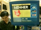 A screen displays the amount of a significantly smaller win -- $5. Four people have won the big Lotto 6-48 $48 million jackpot on Saturday, Feb. 21, 2009.