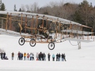 Astronaut Bjarni Tryggvason pilots The Silver Dart replica on the frozen Bras d'Or Lakes, 100 years after Alexander Graham Bell and J.A.D. McCurdy pioneered the first powered flight of an air machine in Canada. (THE CANADIAN PRESS / Vaughan Merchant)