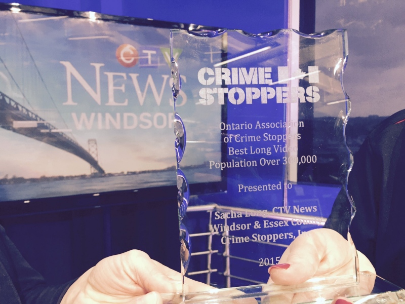 Crime Stoppers presents CTV's Sacha Long with an award on Thursday, Dec. 1, 2016. (CTV Windsor)
