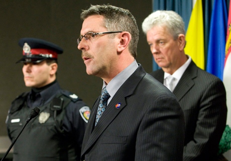 Canadian Association of Chiefs of Police Vice-President Chief Tom Kaye, of the Owen Sound police service, right, and Ottawa Police Sergeant Dodd Tapp, left, listen as President of the Canadian Police Association Charles Momy responds to a question during a news conference on Parliament Hill in Ottawa Tuesday Feb. 24, 2009. (THE CANADIAN PRESS / Adrian Wyld)