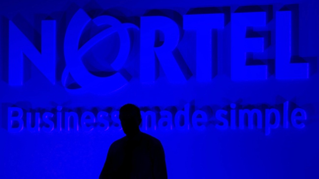 Nortel Networks President and CEO Mike Zafirovski stands in the shadows during his presentation at the company's annual general meeting in Toronto, Thursday, June 29, 2006. (Adrian Wyld / THE CANADIAN PRESS)