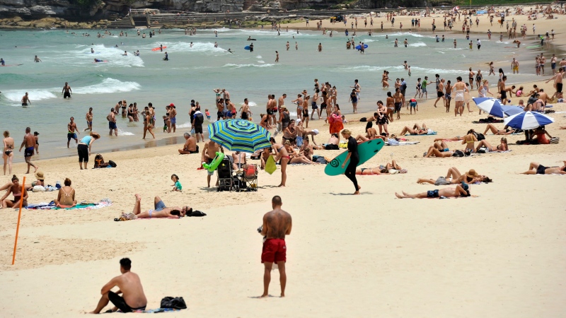 In this Tuesday, Dec. 13, 2016 photo, people gather on the sand at Bondi Beach in Sydney, Australia. (Joel Carrett / AAP Image via AP)