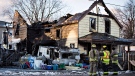 Firefighters survey the damage to a home in Port Colborne, Ontario, where a fire broke out overnight, leaving one person dead on Wednesday, December 14, 2016. THE CANADIAN PRESS/Aaron Lynett