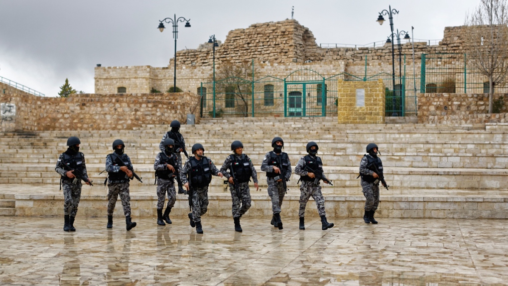 Security forces patrol in front of Karak Castle