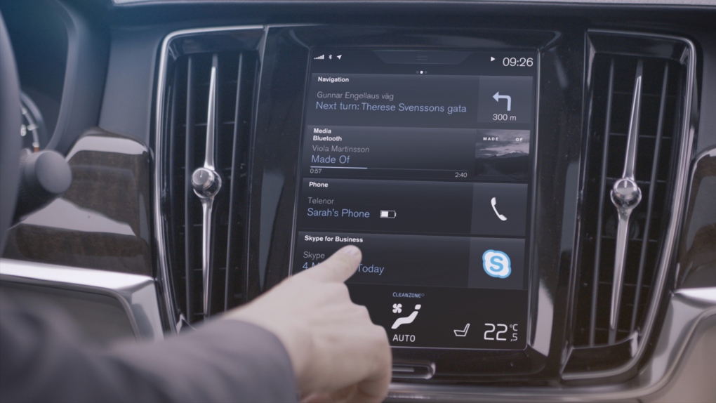 A person uses Skype for Business inside a Volvo 