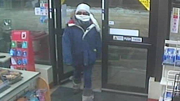 RCMP released security camera images on Jan. 15 showing the suspect enter the store on Main Street with her face covered. (Source: Manitoba RCMP)
