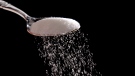 Granulated sugar is poured in a photo illustration. THE CANADIAN PRESS/AP/Matt Rourke
