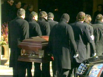 Pallbearers carry a casket inside a Thorncliffe Park church at a funeral service for murdered entrepreneur George Koutroubis.