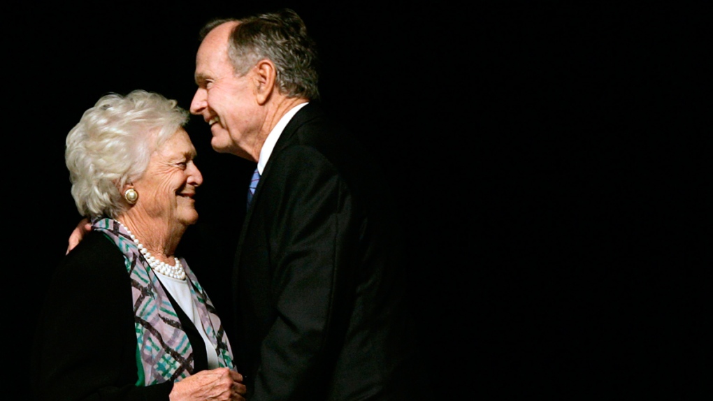 George H.W. Bush embraces Barbara in Dallas