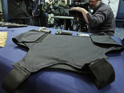 Body armour and weapons seized during several gang-related arrests are displayed during a police news conference in Vancouver, B.C., on Friday, March 6, 2009. (THE CANADIAN PRESS / Darryl Dyck)