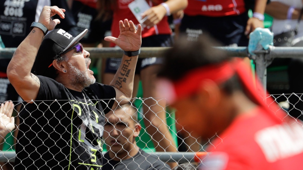 Diego Maradona, left, cheers in Buenos Aires