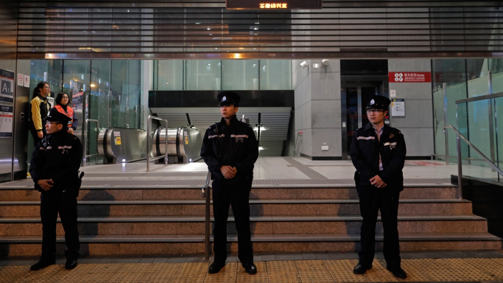 Police guard a subway station in Hong Kong