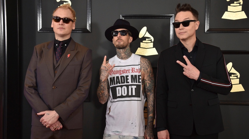 Matt Skiba, from left, Travis Barker, and Mark Hoppus of the musical group Blink 182 arrive at the 59th annual Grammy Awards in Los Angeles. (AP / Invision / Jordan Strauss)
